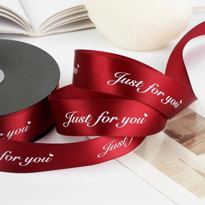 Glitter-accented ribbon featuring a client’s logo in precise printing detail.
