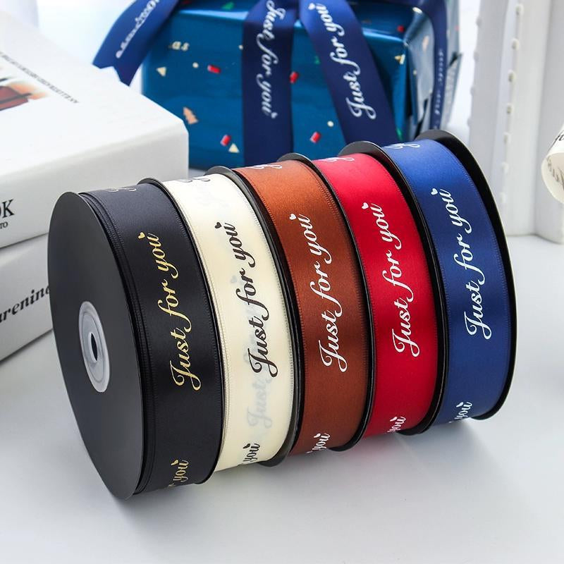 Custom ribbon with metallic edging and Pantone-matched brand colors.